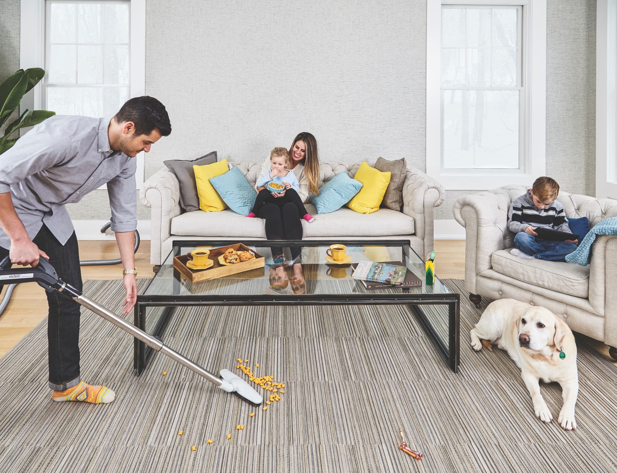 Family enjoying their home while dad vacuums with a central vacuum system